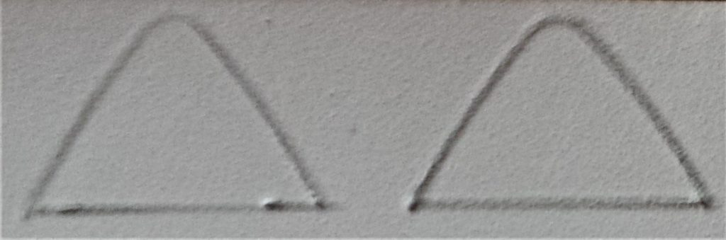 Two triangle shapes drawn on white foam card with a pencil.