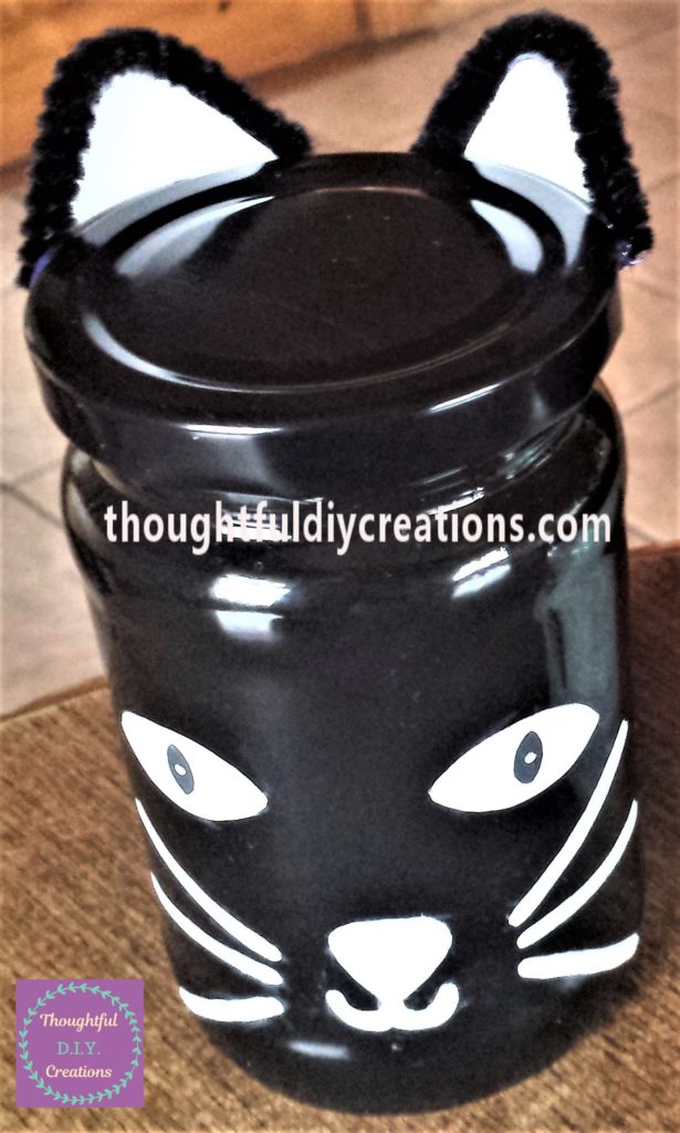 The cats ears attached to the edge of the lid.