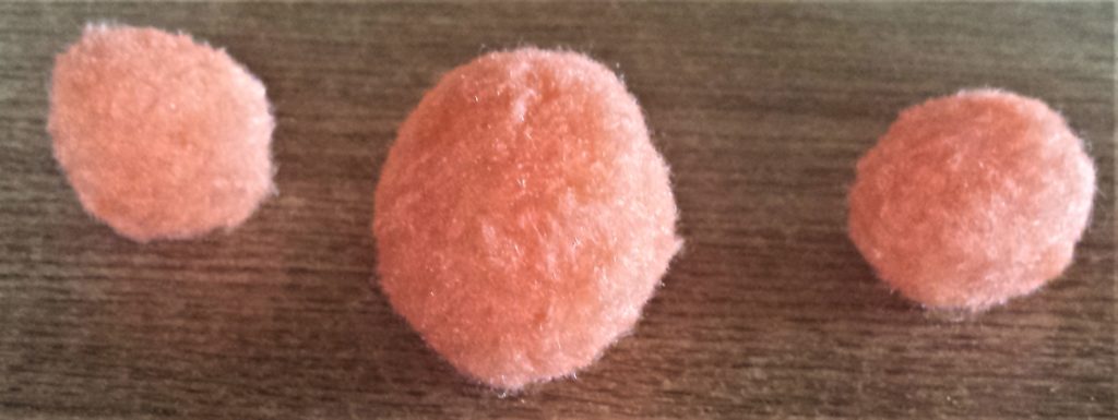 3 Orange pom poms.