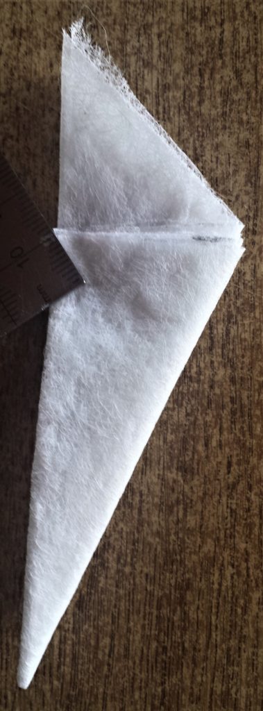 Right edge of the triangle brought over to the left edge of the triangle and folded over.