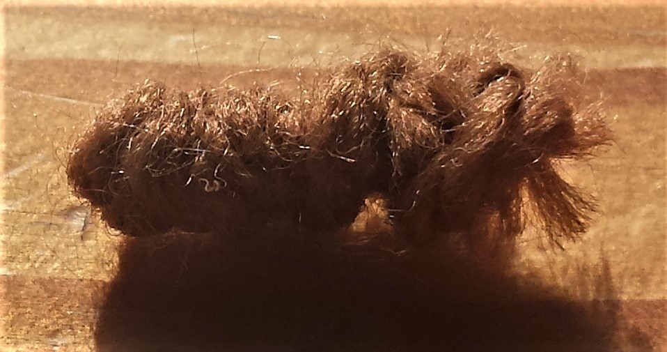 Brown wool wrapped around the pink pipe cleaner.