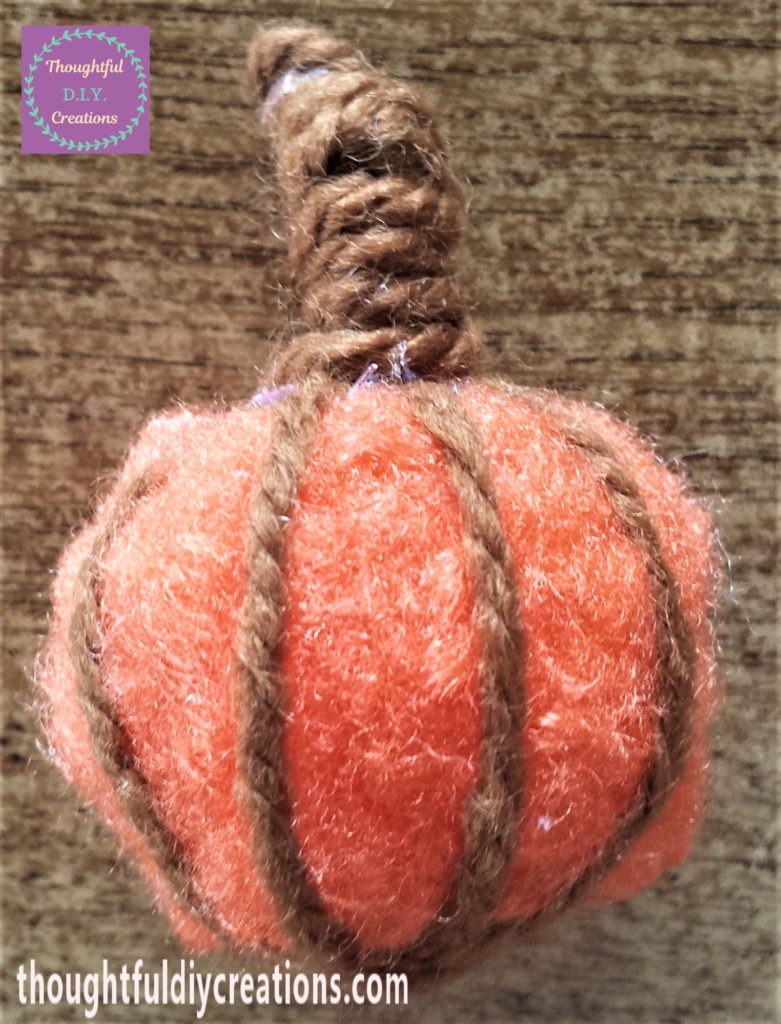 Brown wool pipe cleaner added to the pom pom.