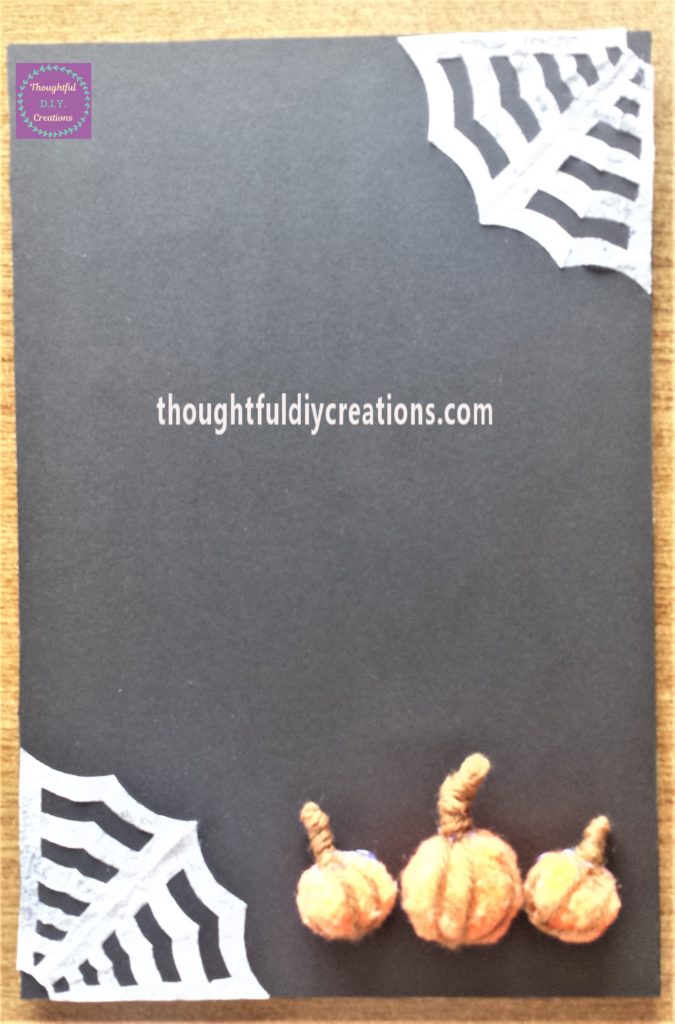 Pumpkins hot glued to the Halloween sign.