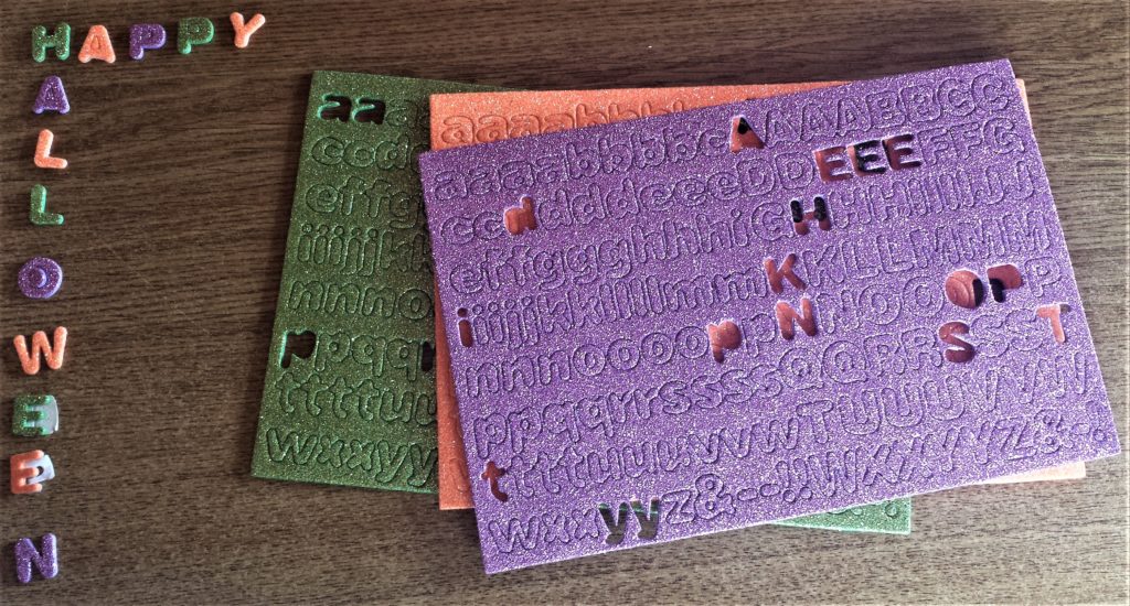 Green, Orange and Purple alphabet colours to spell out Happy Halloween.