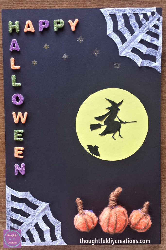 Stars added to the night sky using a yellow glitter gel pen.