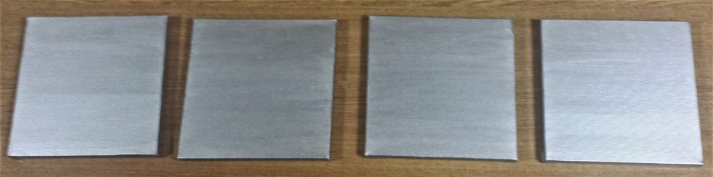 Second coat of paint on the four canvases.