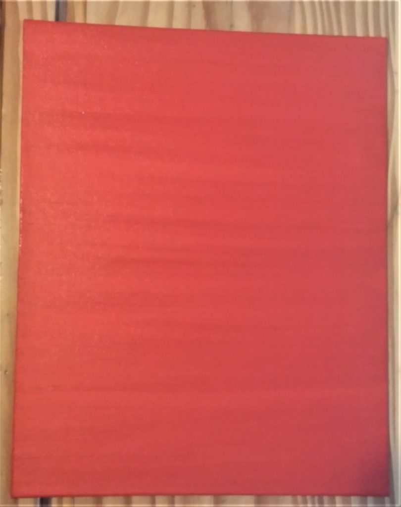 Red acrylic paint on the canvas board.