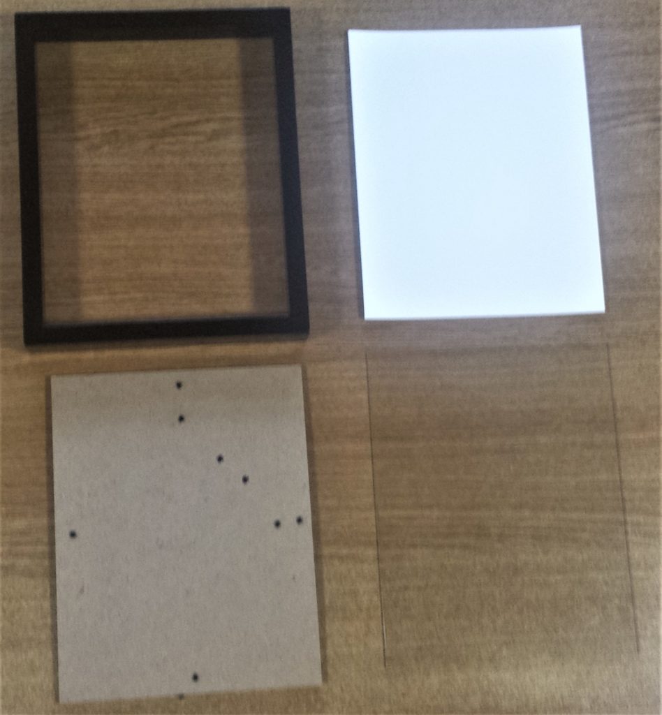 The frame opened with the back, the white board and the glass out of the frame.