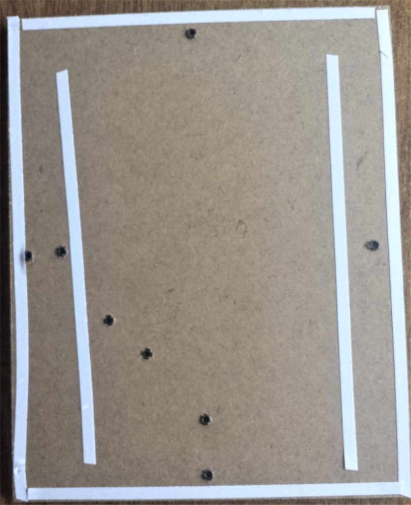 Double sided tape on the brown backing board.