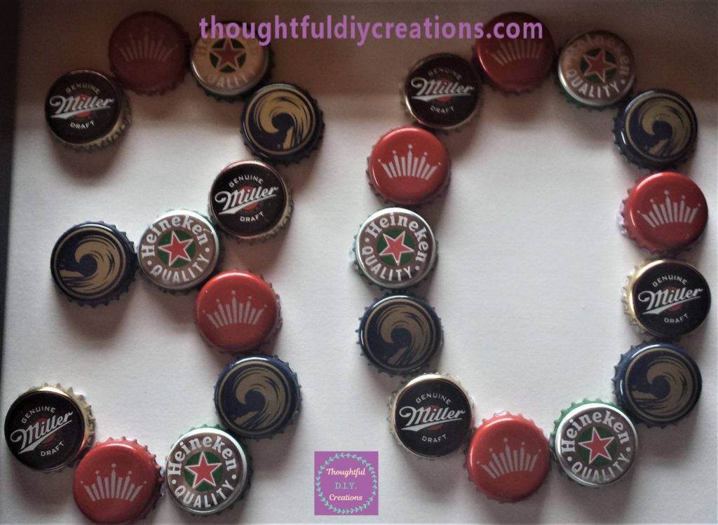 Close up of the beer bottle caps on the frame.