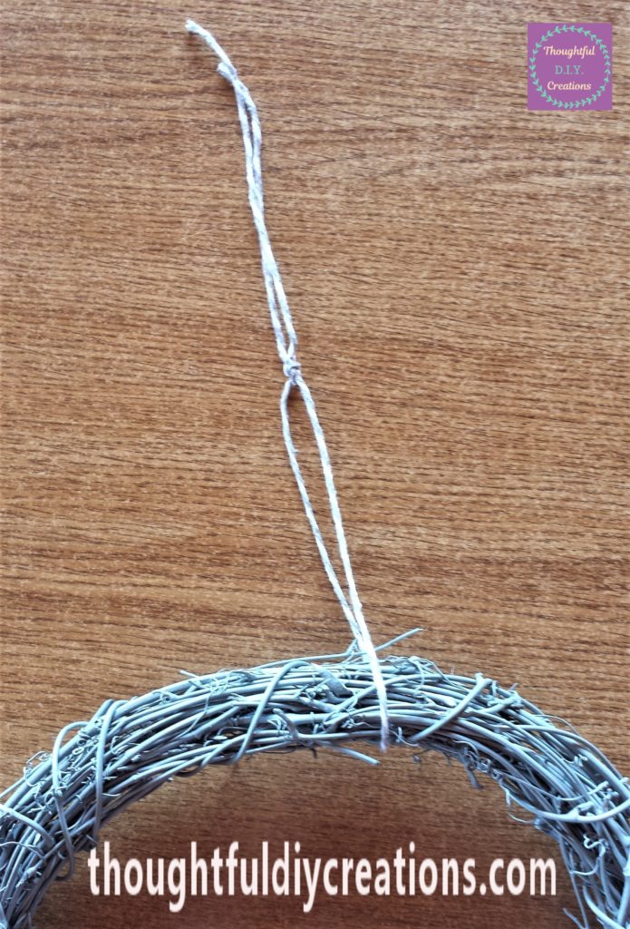 String tied around the wreath and secured with a few knots in it.