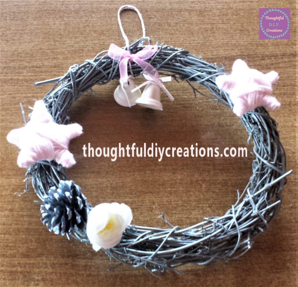 Pine cone and flower glued to the wreath.