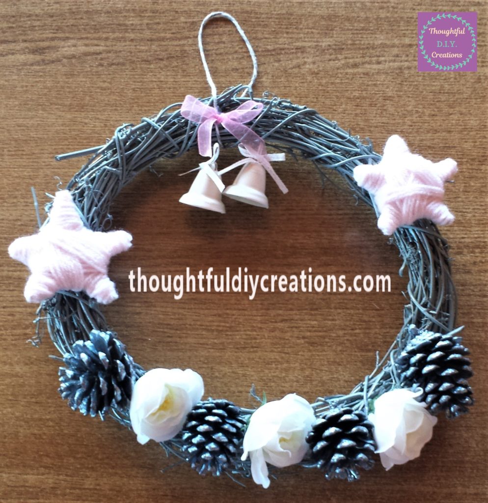 2 more pine cones and 1 more flower added to the wreath.