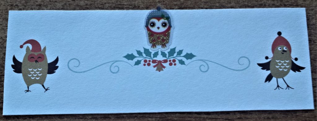 Sticker of an owl added to the cut out Christmas card.
