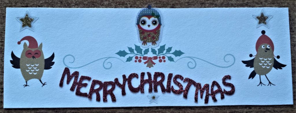 Merry Christmas sticker and 2 gold star stickers and 1 clear star sticker added to the Christmas card.