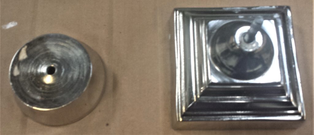 The 2 pieces of the jar on cardboard on a table in the shed ready for spray painting.