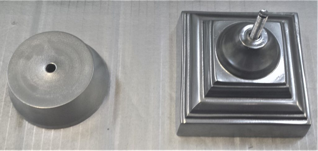 The 2 pieces of the candle jar after being spray painted.