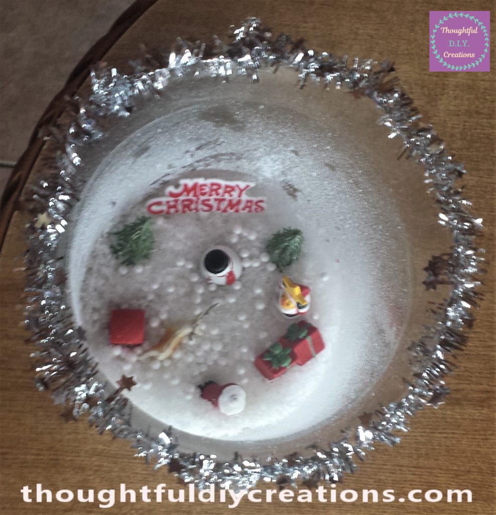 Silver tinsel hot glued to the top of the glass jar.