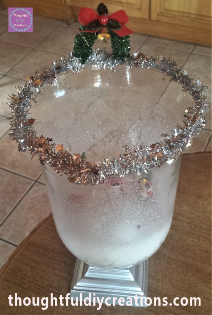 The archway hot glued onto the tinsel.