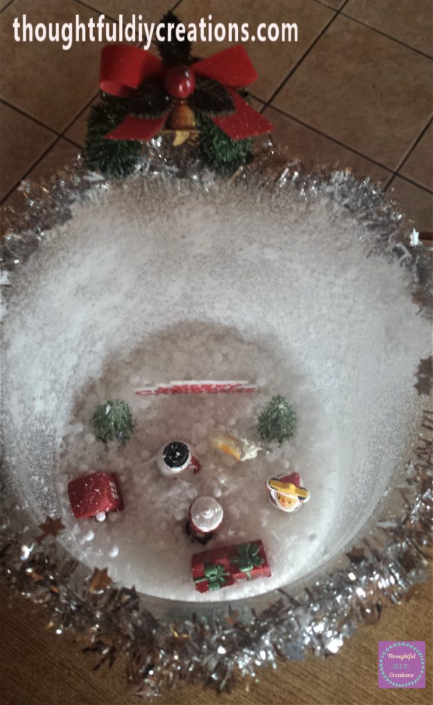Snow spray added inside the Christmas scene jar.