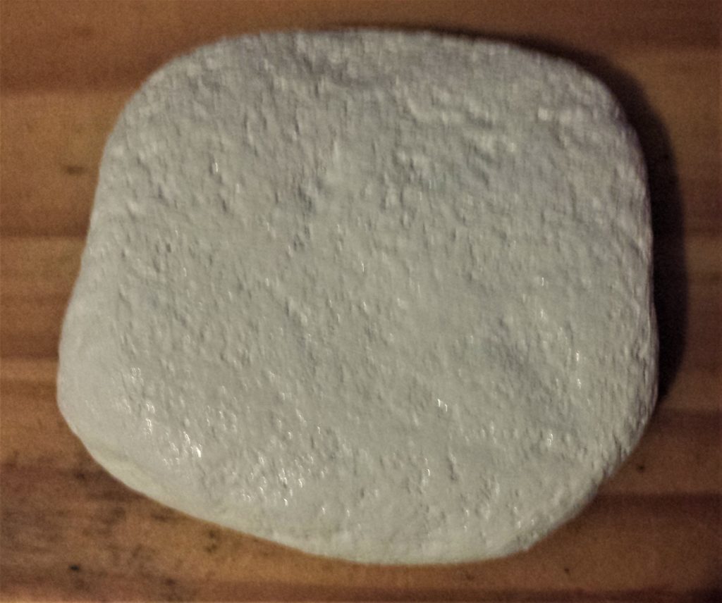 Second layer of white paint on the stone.