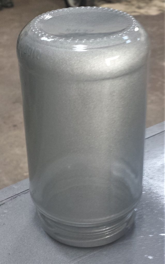 One layer of spray paint on the jar.