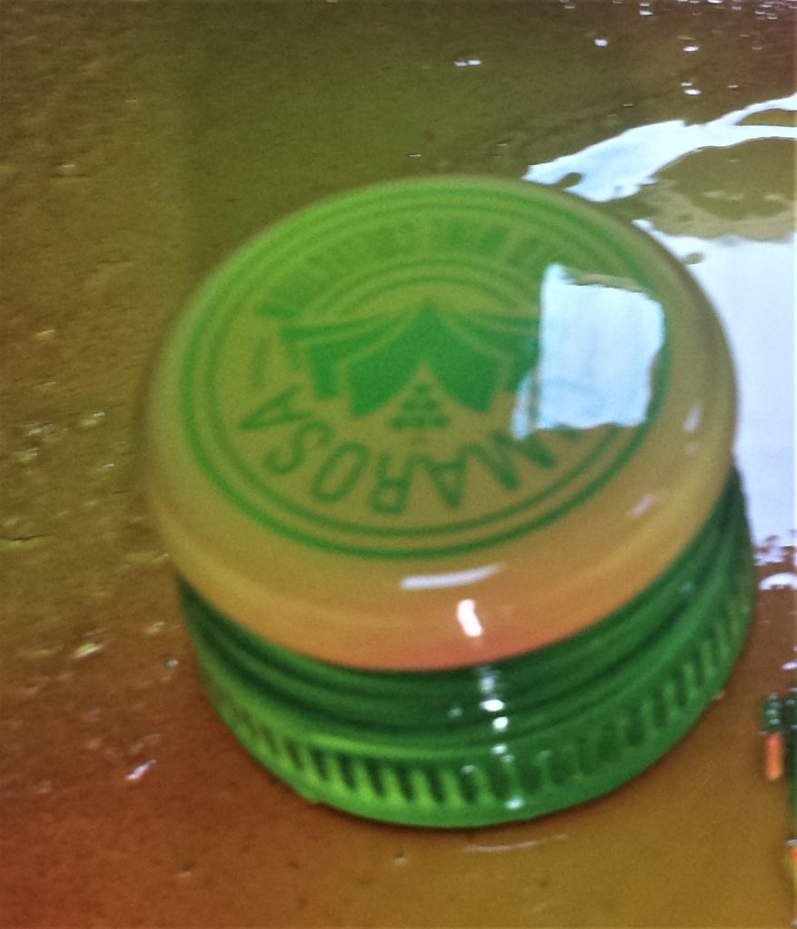 The lid of the wine bottle spray painted.