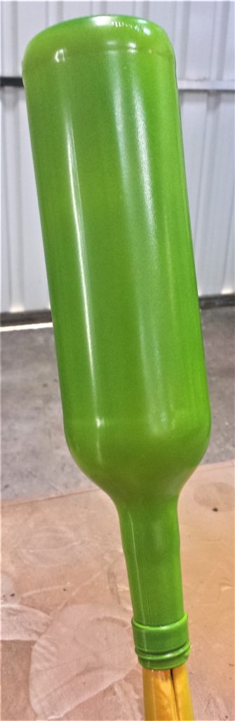 The fourth and final layer of spray paint on the bottle.