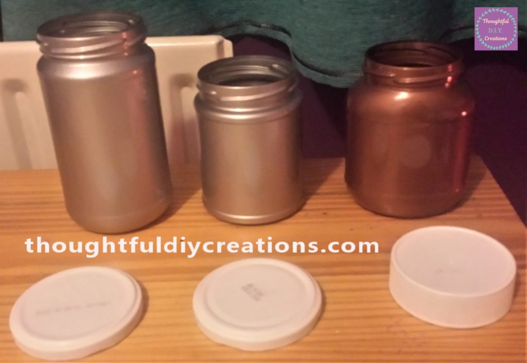 The three jars and their lids after being painted.