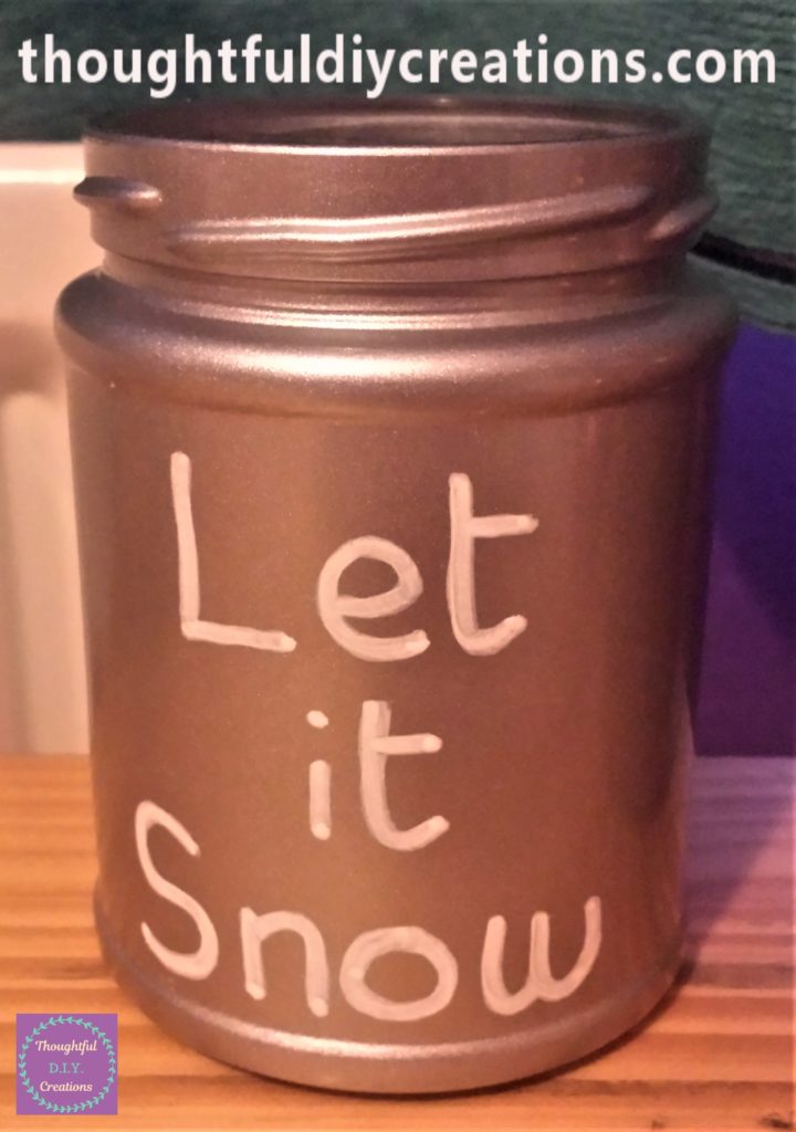 'Let it Snow' written on the small silver jar with the white acrylic marker.