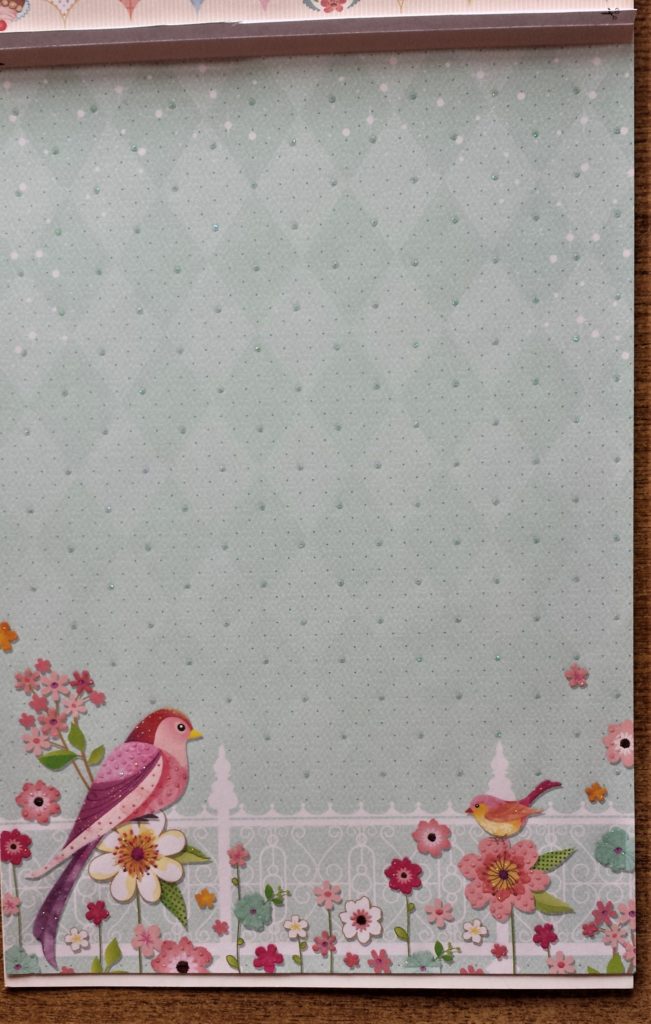 Blue page with 2 birds and flowers on it.