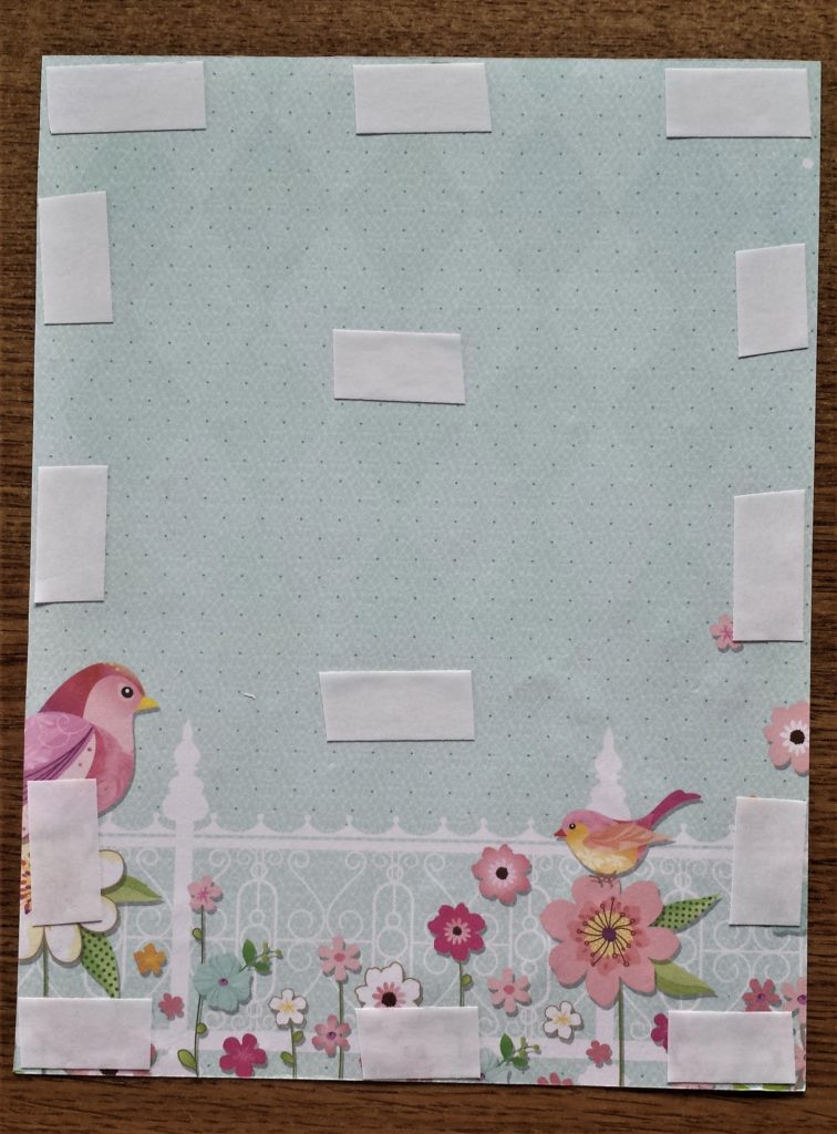 Double-sided tape on the back of the blue patterned page.