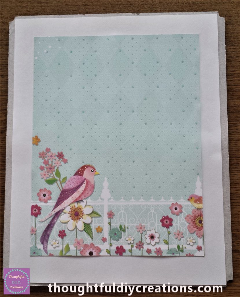 The blue patterned page attached to the white sheet on the backing of the frame on the measurements I had marked.