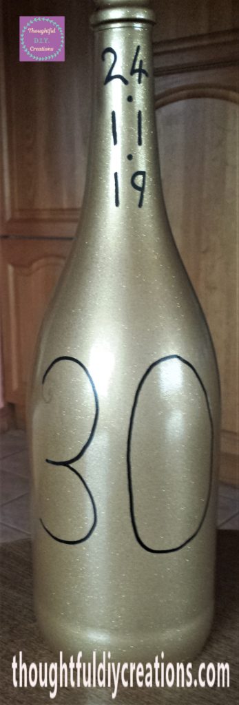 The number 30 drawn onto the middle of the bottle with the paint marker.