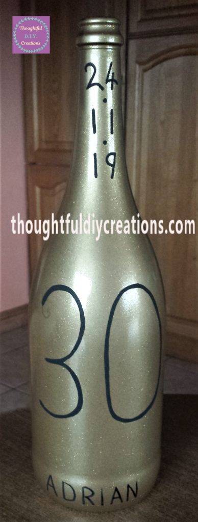 The name ADRIAN added to the bottom of the bottle with the paint marker.