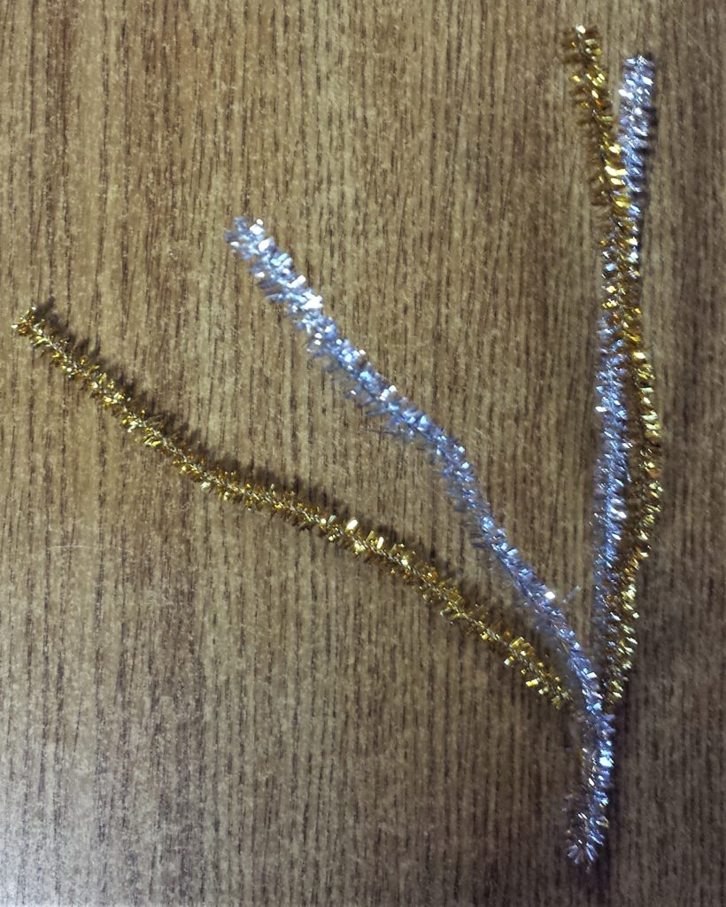 The last silver and gold glitter pipe cleaners hot glued together on the bottom.