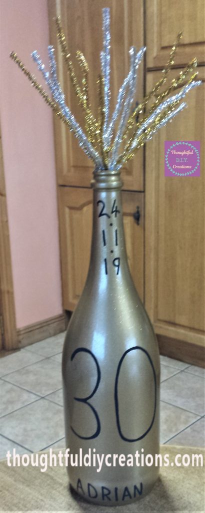 Different angle of the pipe cleaners hot glued to the mid-section of the bottle.