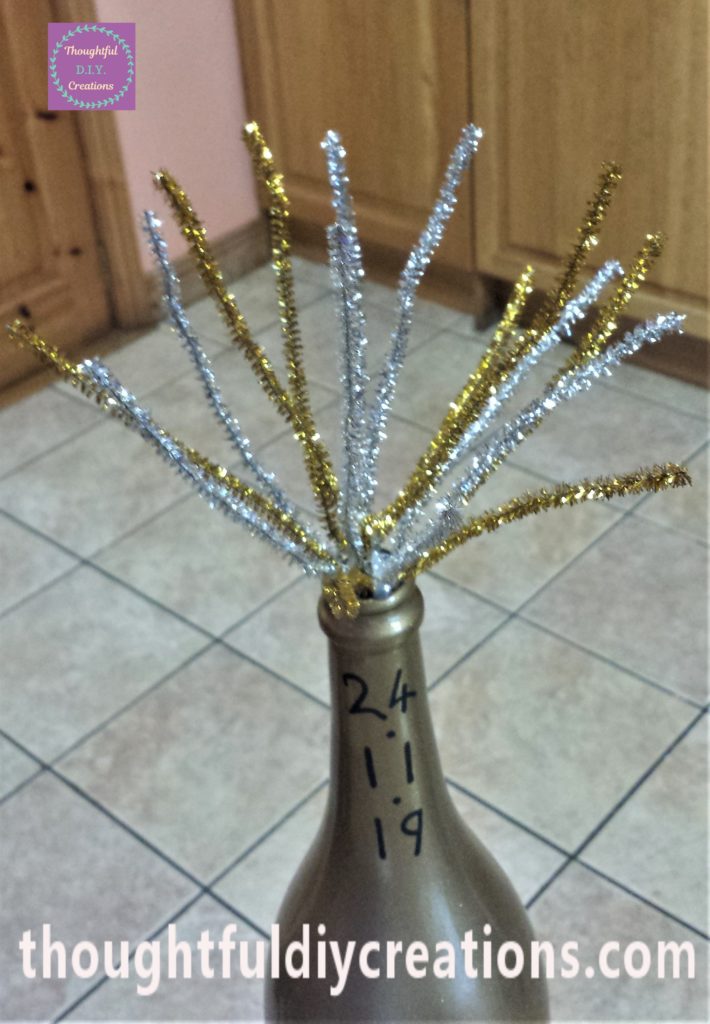 The middle section of pipe cleaners hot glued to the inside of the botle.