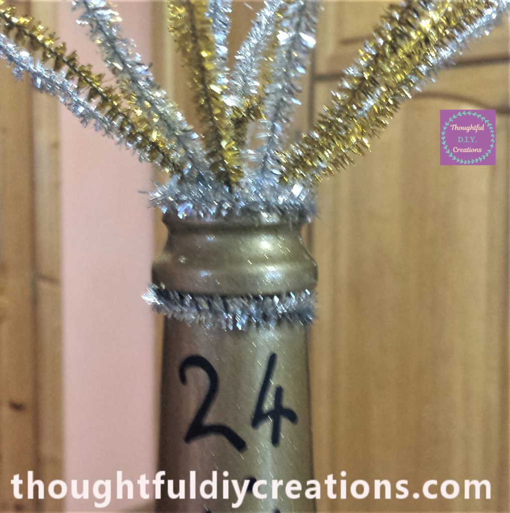 Silver glitter pipe cleaner hot glued to the neck of the bottle.