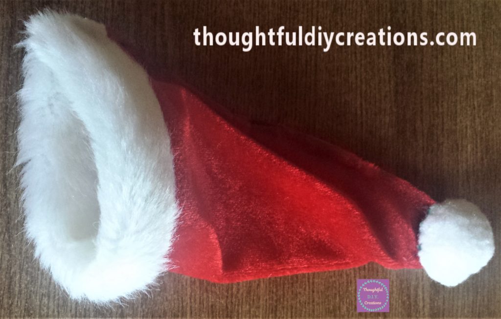 The pom pom hot glued to the opening of the hat.