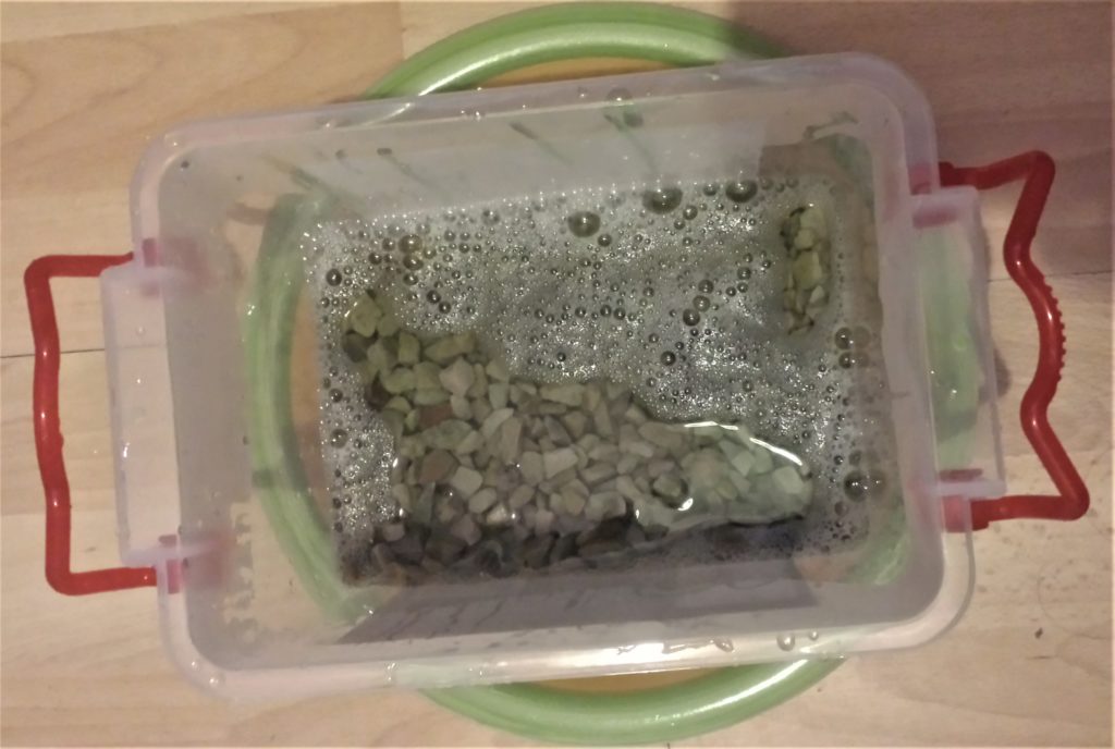 Garden stones in a container with warm water and washing- up- liquid for a couple of hours.