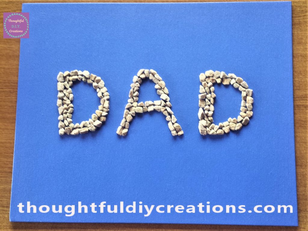 The stones glued to the canvas board using wood glue.