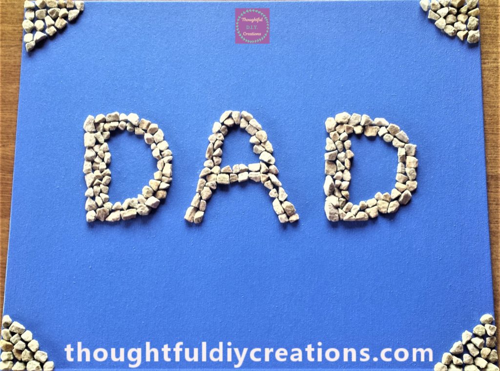 The four corners of the canvas filled with stones in a triangle shape.