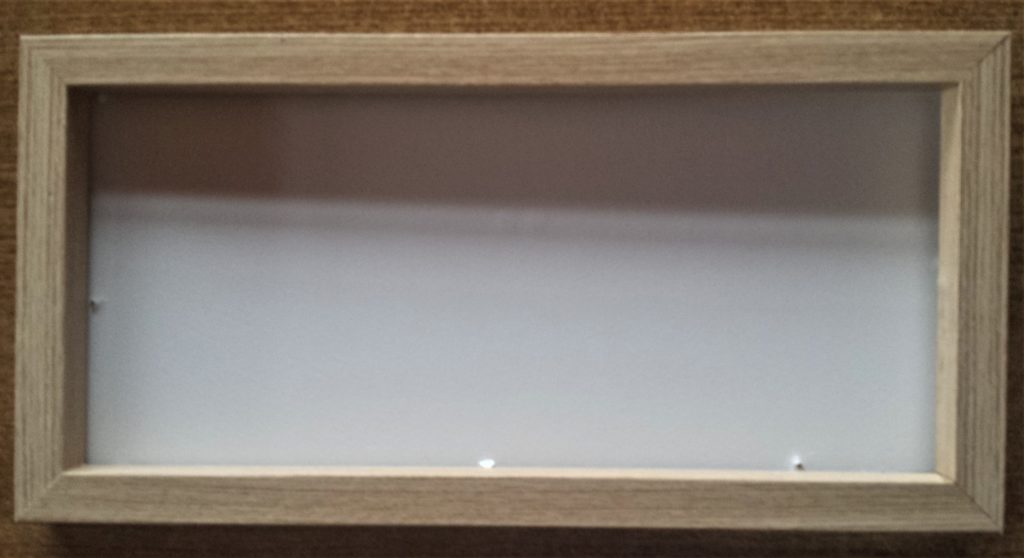 Plastic wrapper removed from the frame and the mini pegs, string and paper taken out of the frame.