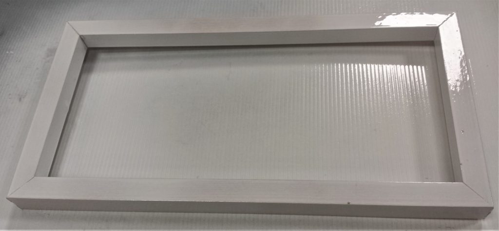 First layer of white spray paint on the frame.