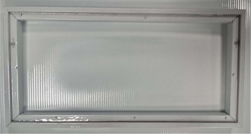 The first layer of spray paint on the back of the frame.