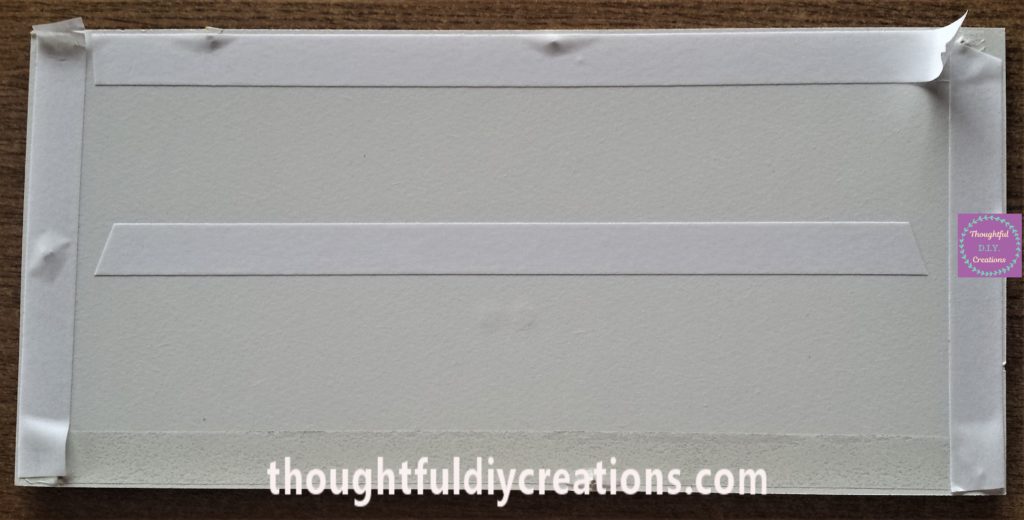 Double-sided tape on the backing board of the frame.