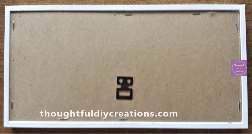 Backing board stapled to the frame.