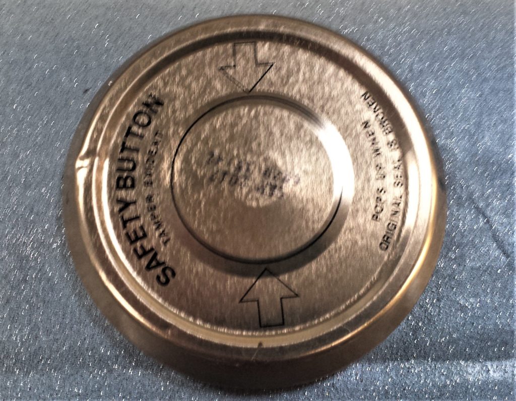 Lid on the table in the shed ready for spray painting.