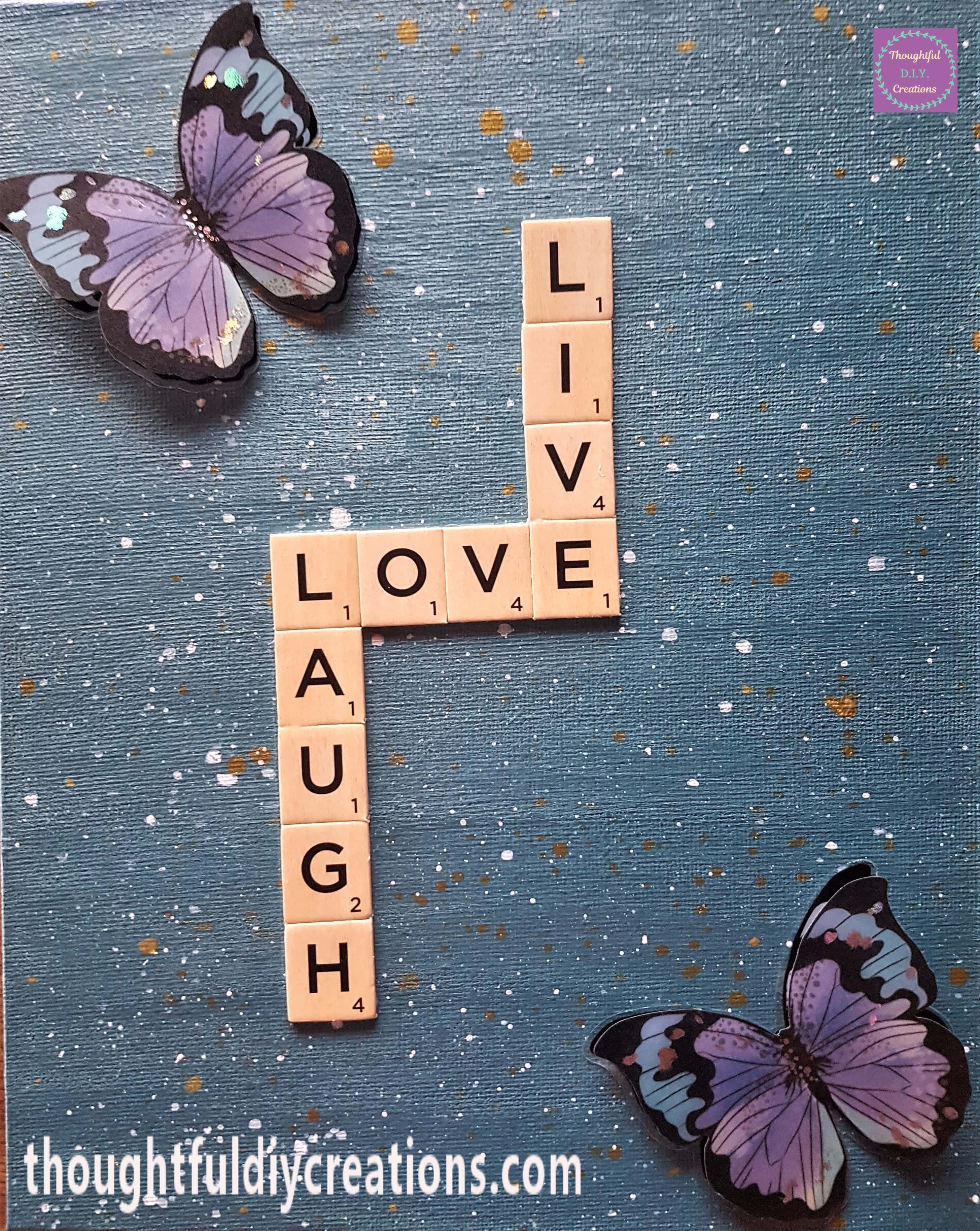 The 2 Purple, Teal and Black Butterfly Stickers attached to the top and bottom corners of the canvas.